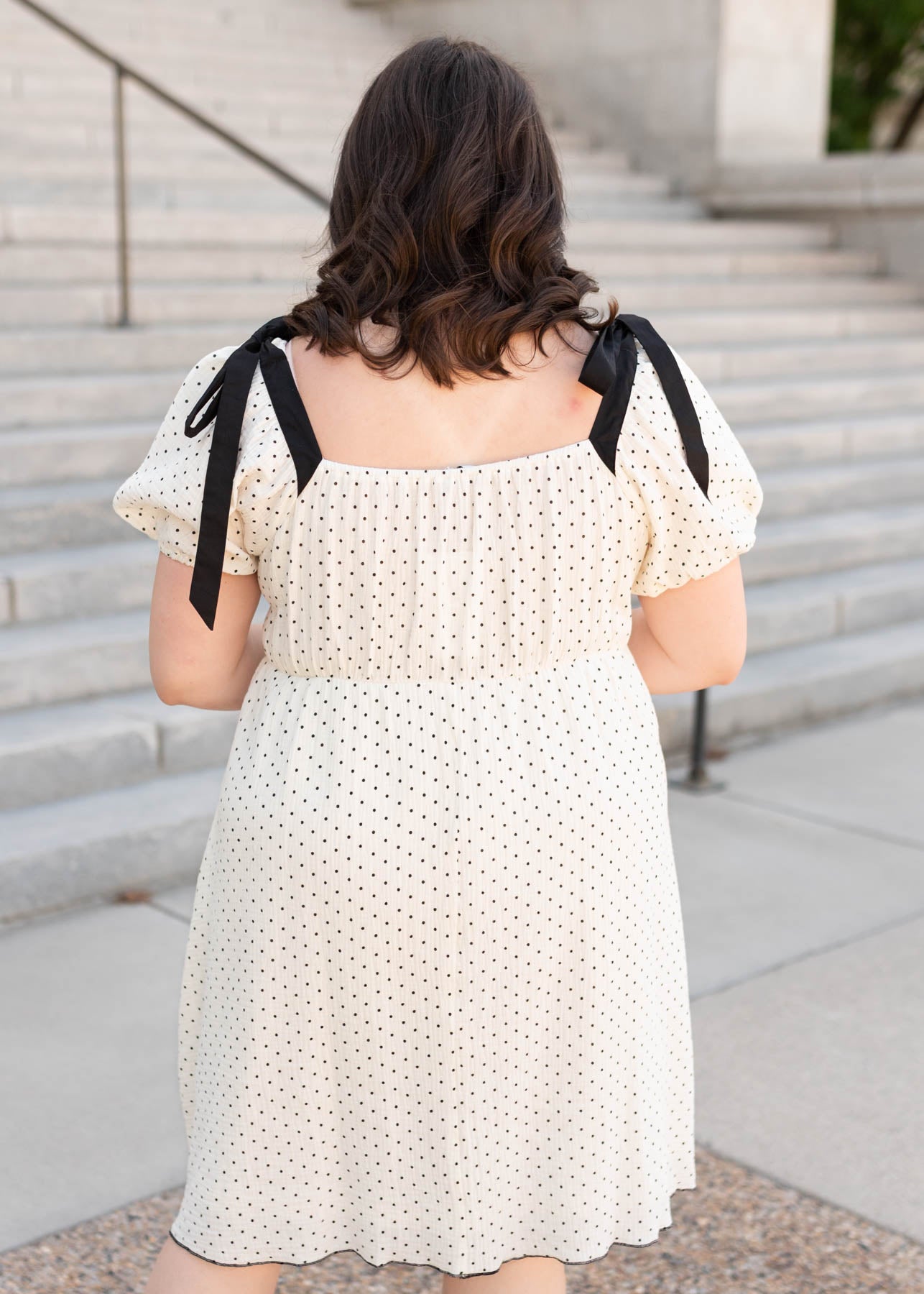Back view of the plus size ivory polka dot dress