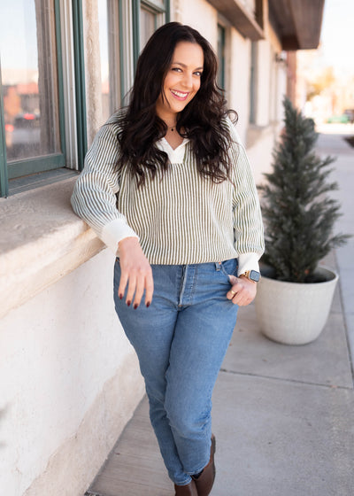 Cream cuffs and neckline on the olive striped sweater
