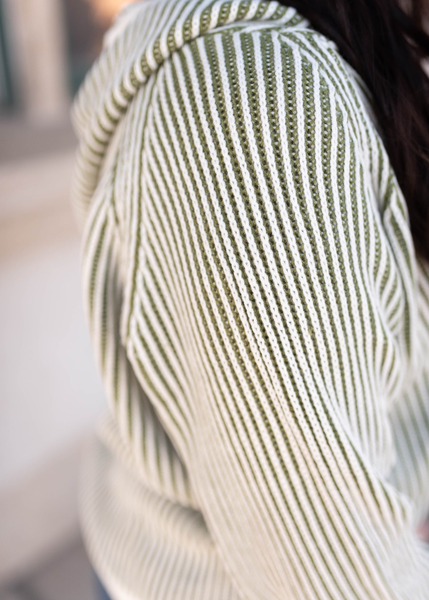 Close up of the knit on the olive striped sweater