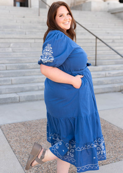 Side view of the plus size blue embroidered dress with pockets