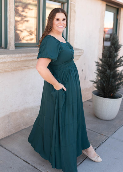 Side view of the plus size green smocked dress with pockets and short sleeve 