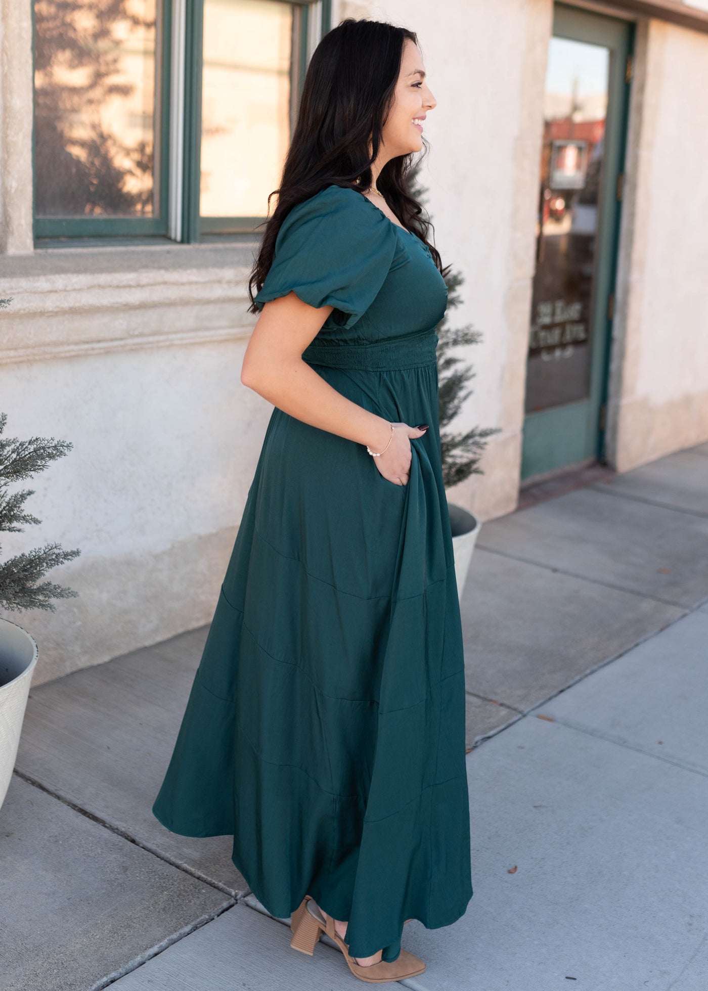 Side view of the modest green smocked dress in plus size
