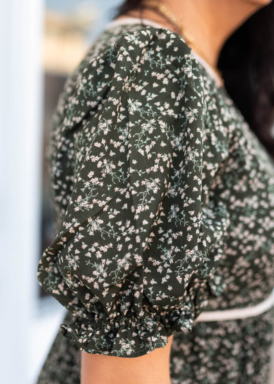 Close up of the sleeve and fabric on the dark olive floral dress