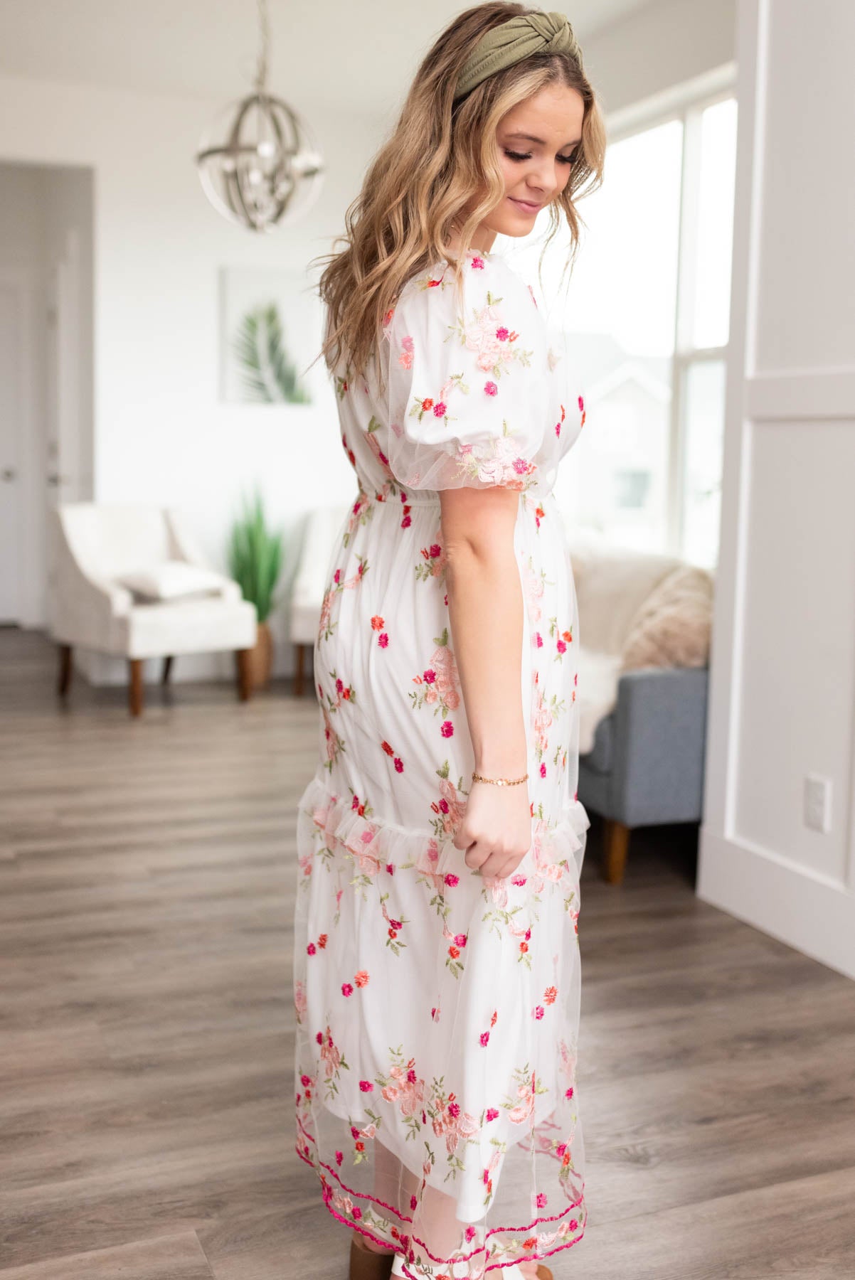 Side view of a white embroidered floral dress
