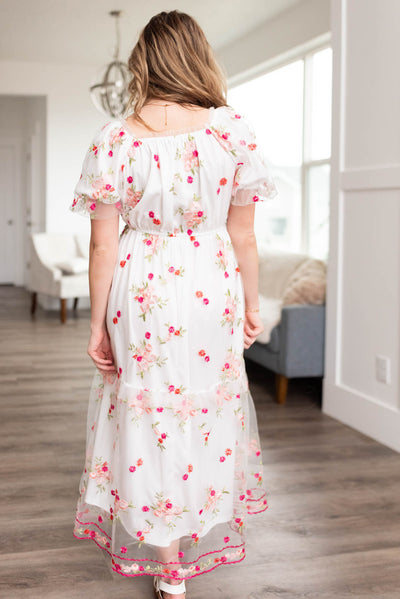 Back view of a white embroidered floral dress