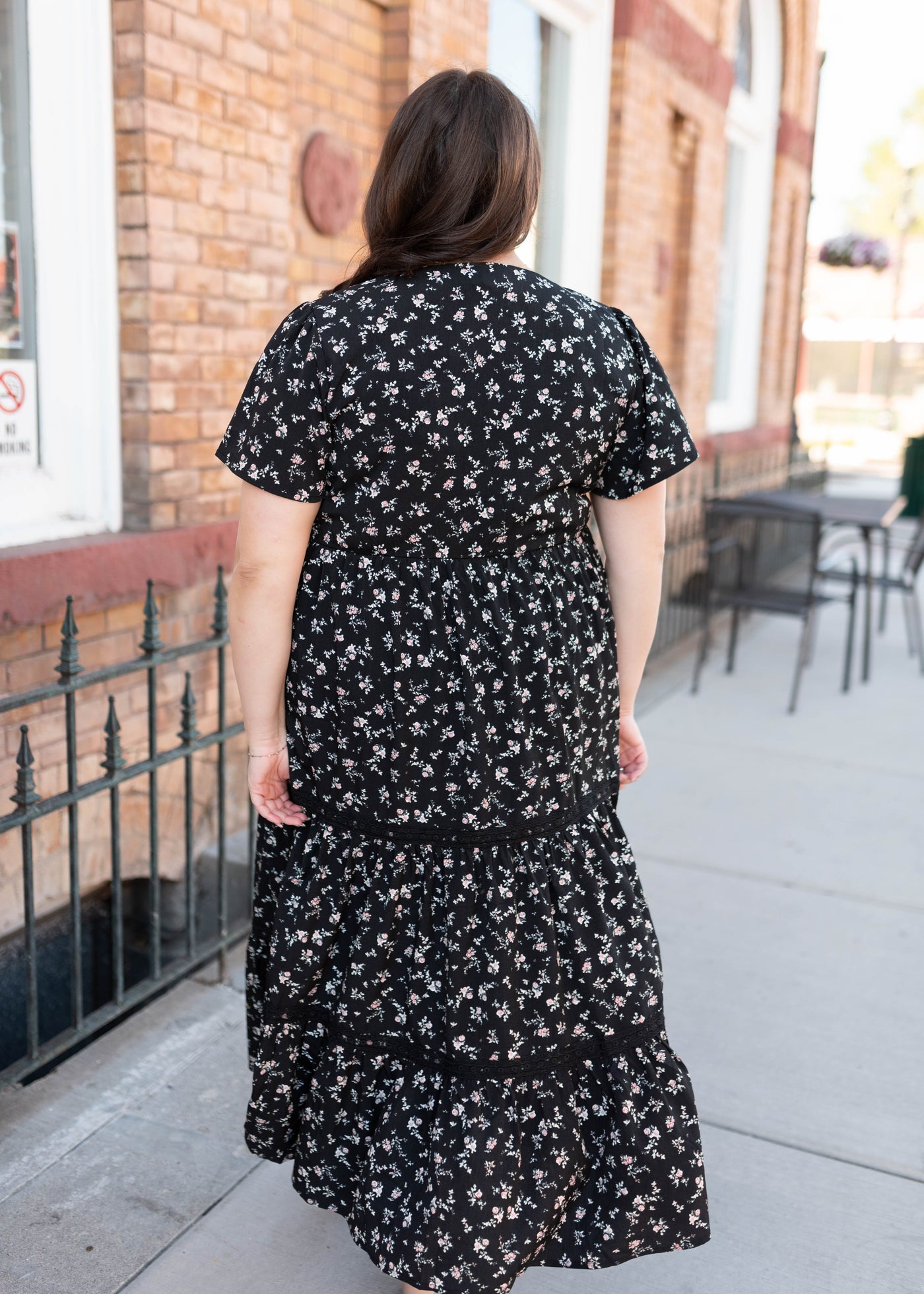 Back view of the plus size black floral dress