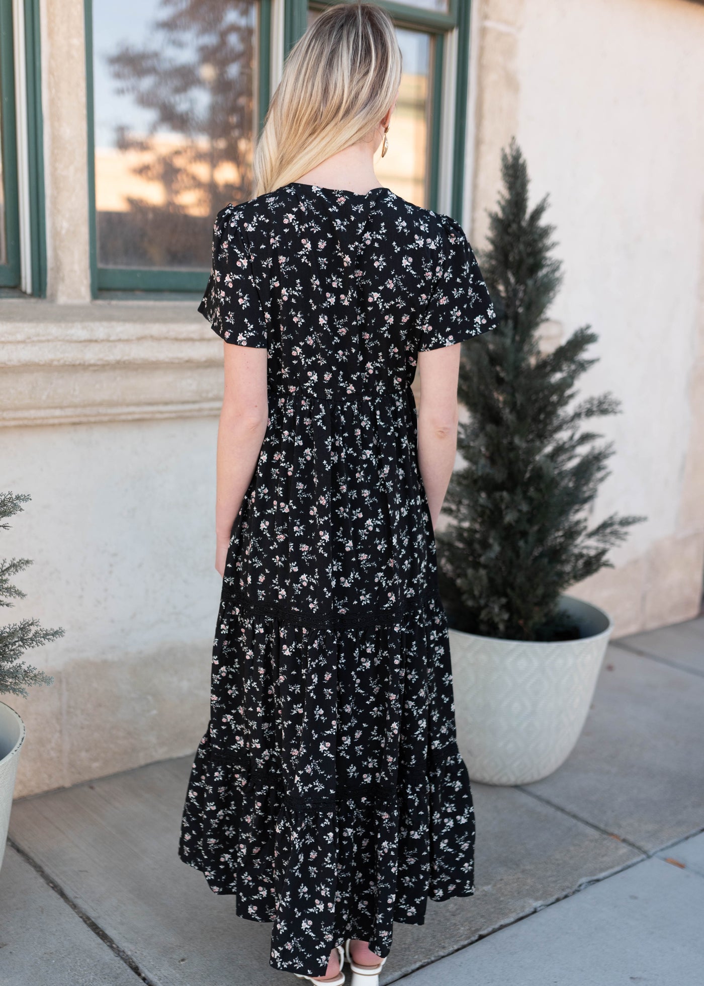Back view of the black floral dress with pale pink flowers