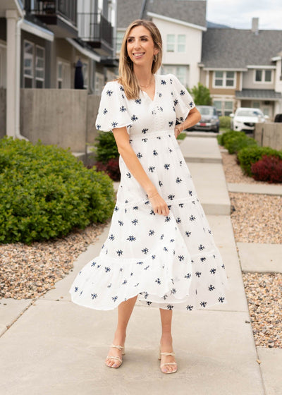 White embroidered dress with blue flowers