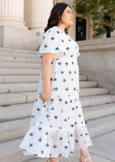 Side view of the white embroidered dress in plus size