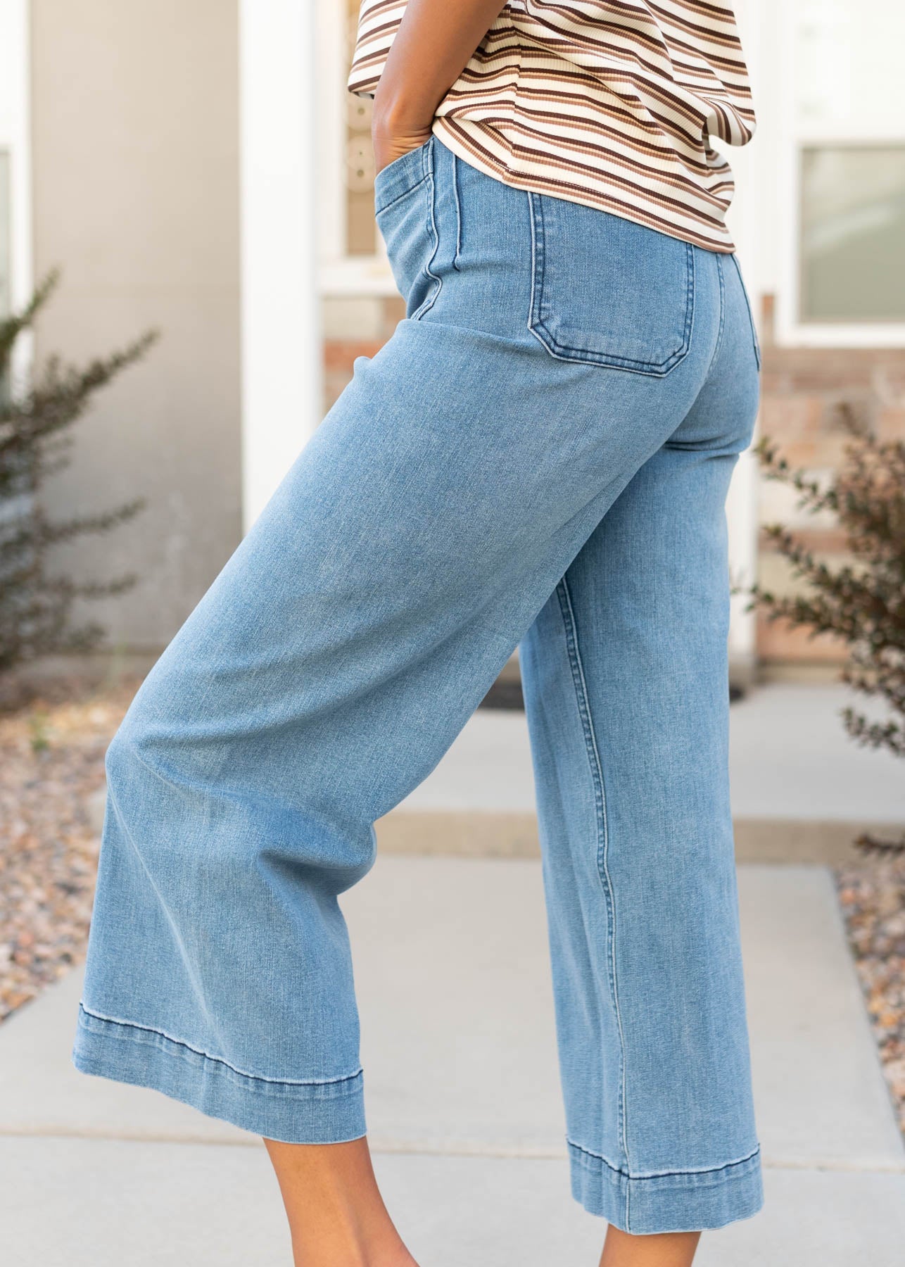 Side view of the dark denim pants