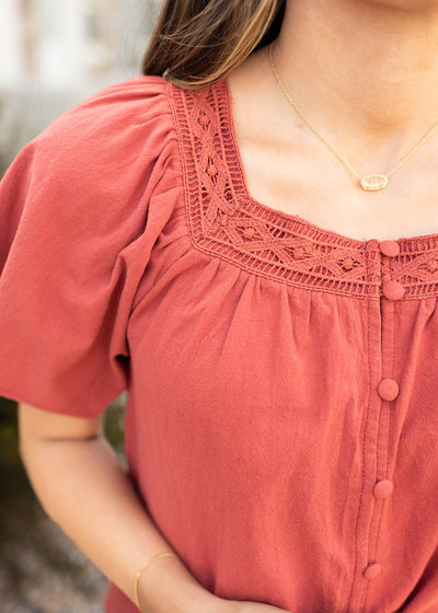 Close up of the lace on the neck of the modest teracotta square neck top