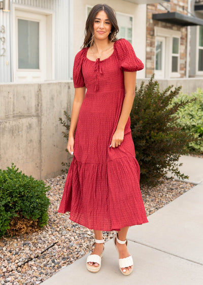 Puff sleeves on a modest burgundy textured dress