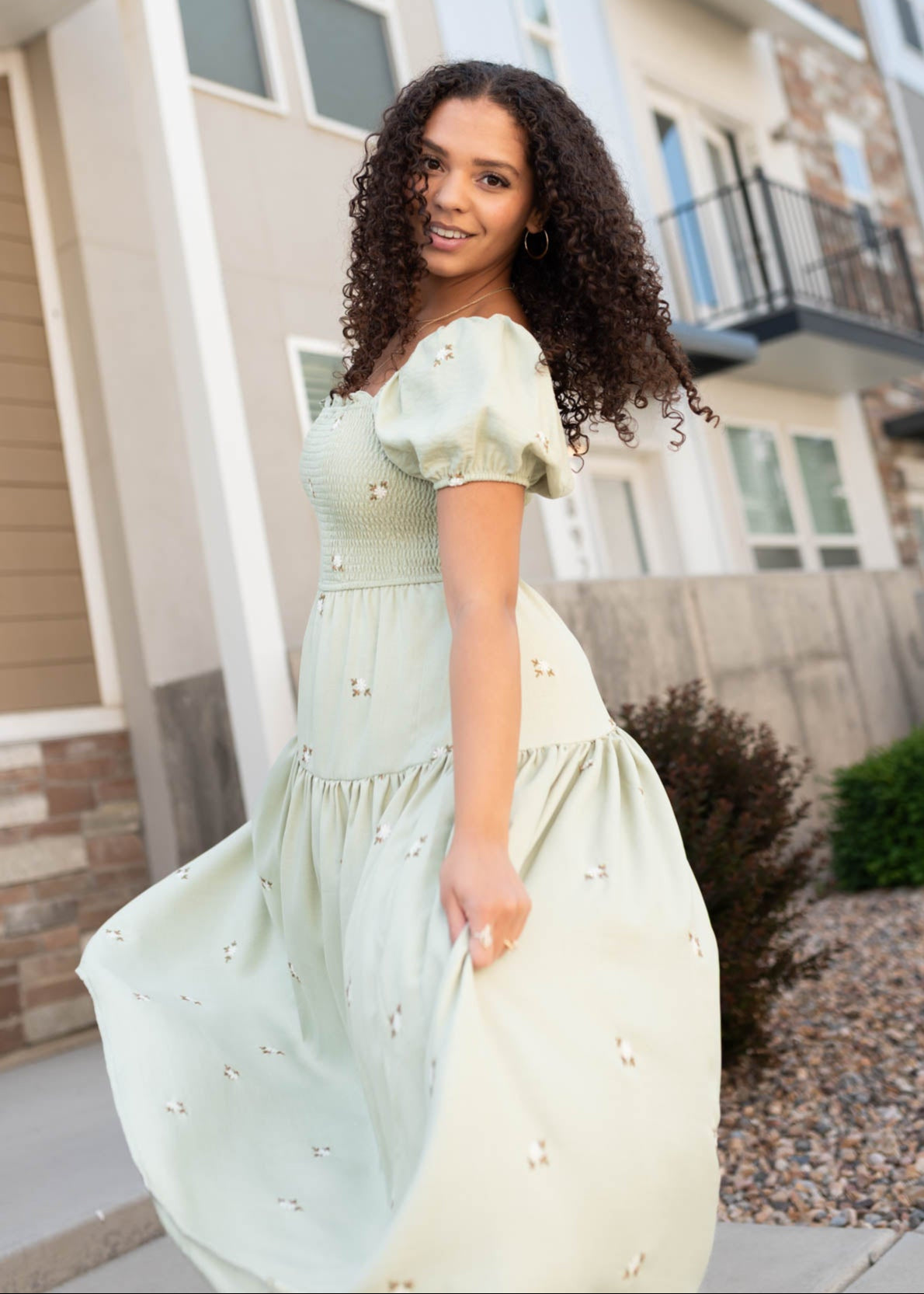 Side view of the olive puff sleeve dress with smocked bodice