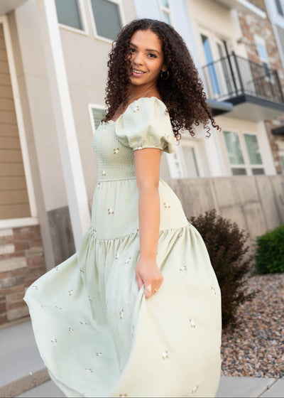 Side view of the olive puff sleeve dress with smocked bodice