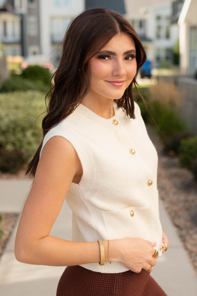 Side view of the modest ivory sweater vest with pockets