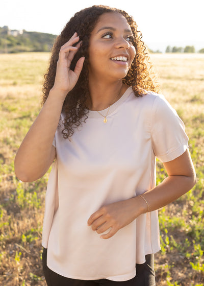 Blush top with a round neck and short sleeves