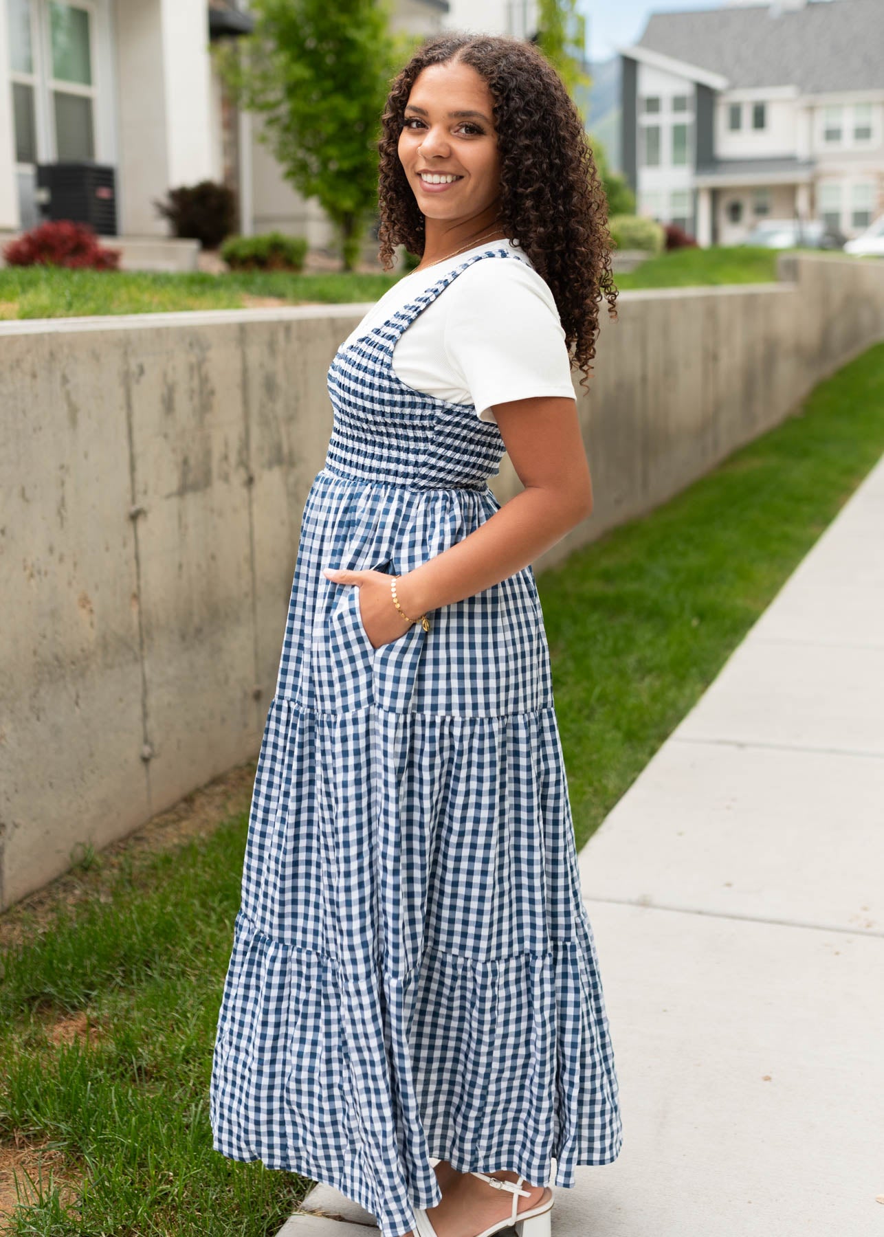 Side view of the navy gingham sleeveless dress