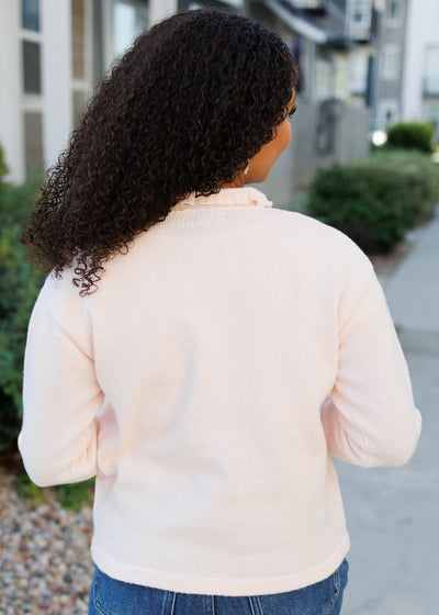 Back view of the light pink cardigan 