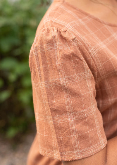 Close up of the sleeve and fabric on the cinnamon plaid dress