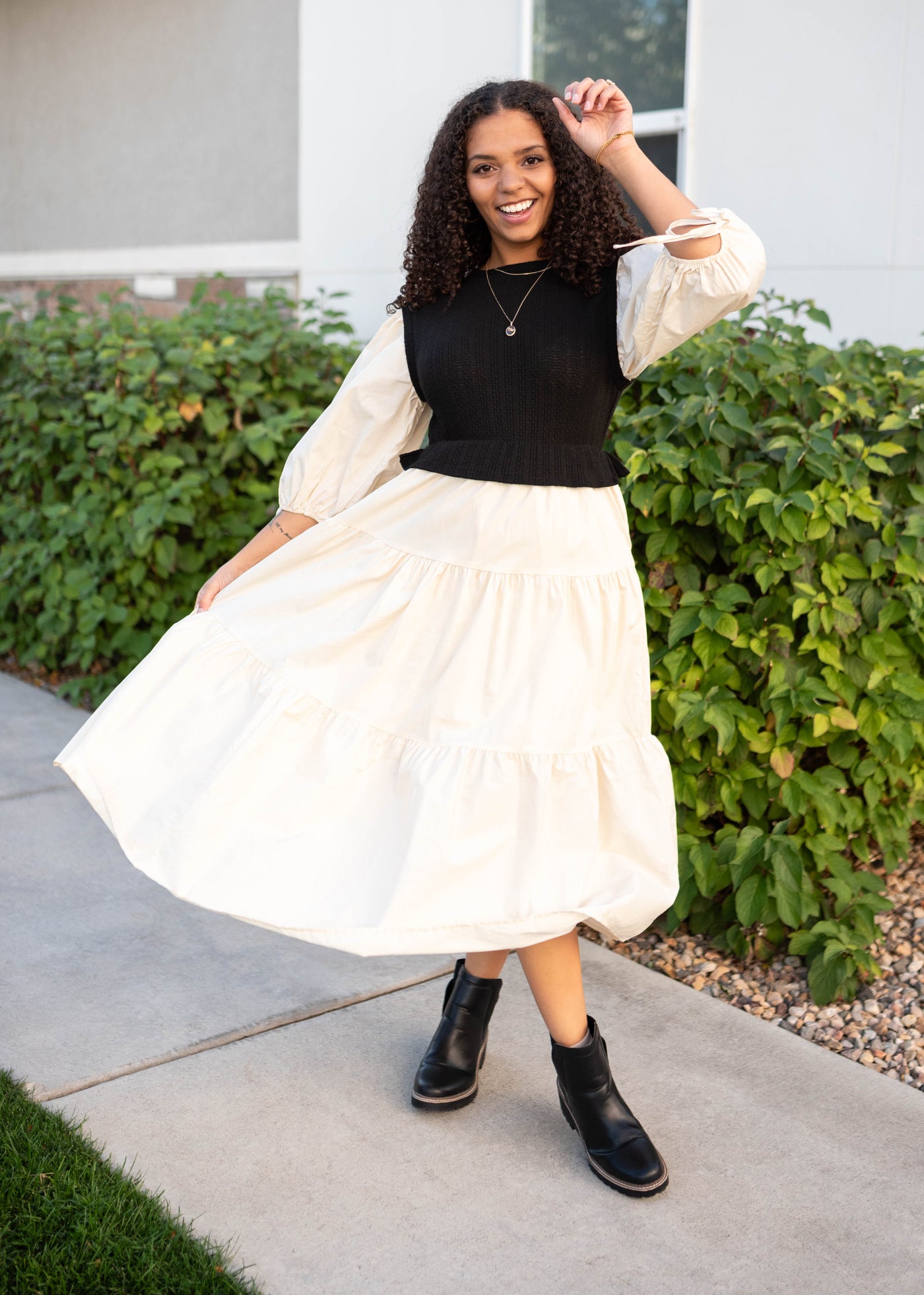 Cream tiered skrit and sleeves on the black sweater vest dress with short sleeves