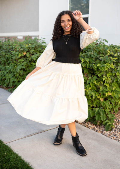 Cream tiered skrit and sleeves on the black sweater vest dress with short sleeves