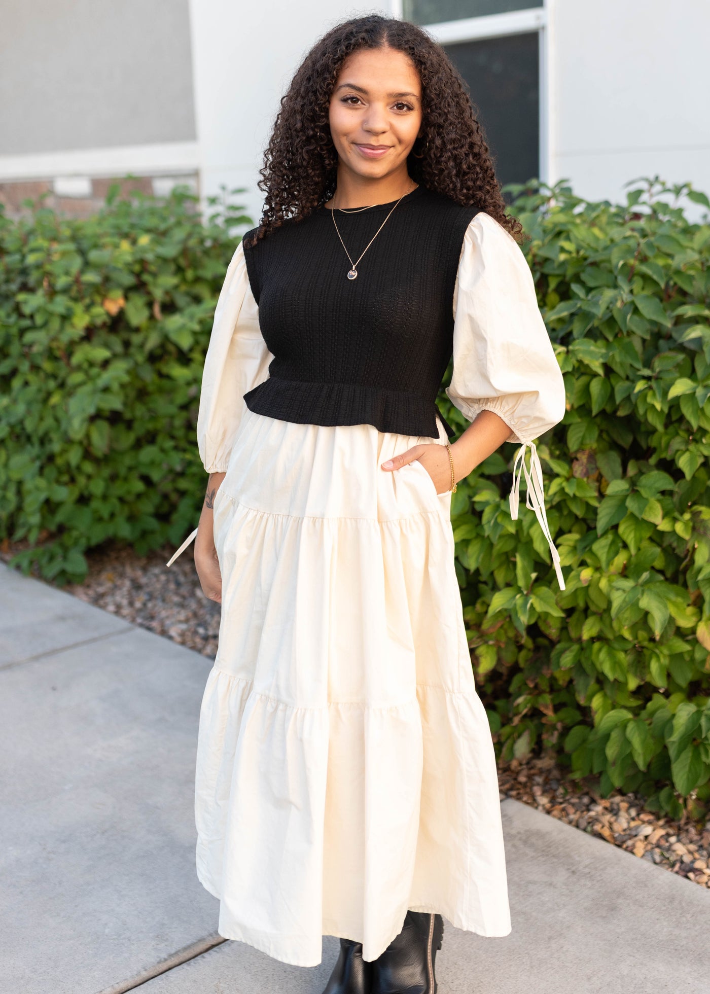 Modest black sweater vest dress with cream tiered skirt and sleeves