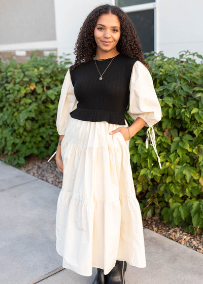 Modest black sweater vest dress with cream tiered skirt and sleeves