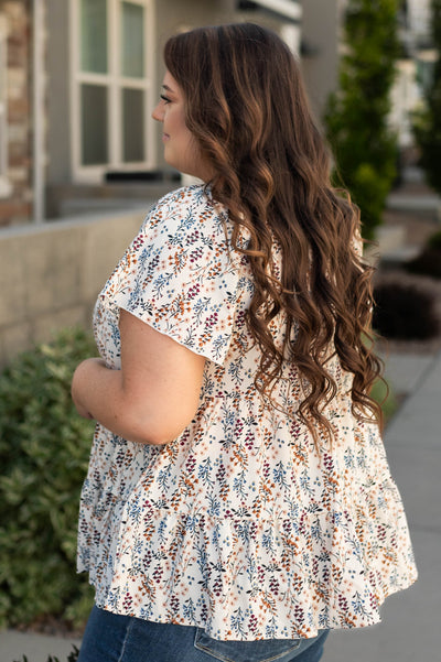 Side view of a plus size ivory top