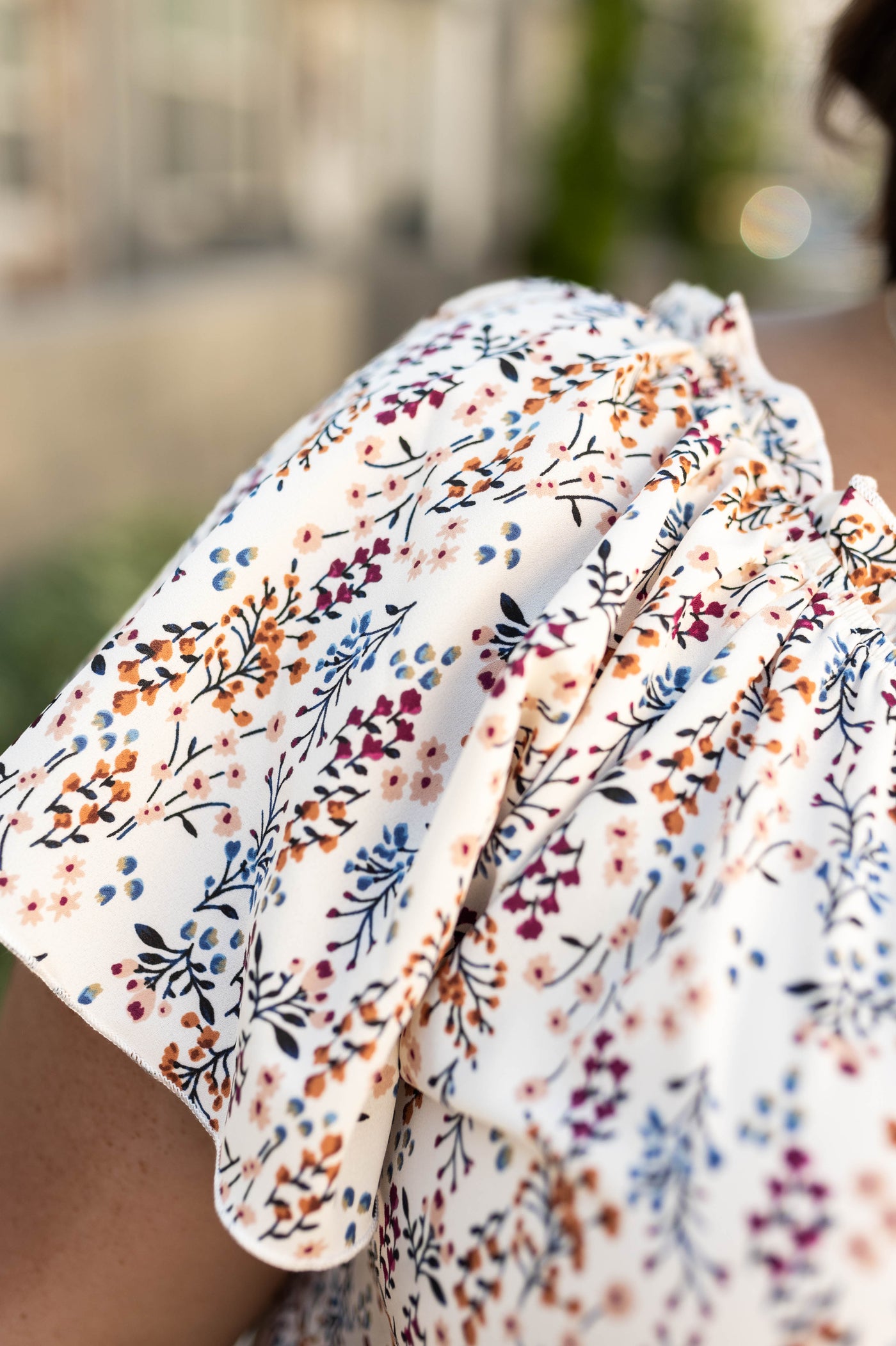 Sleeve of a plus size ivory top