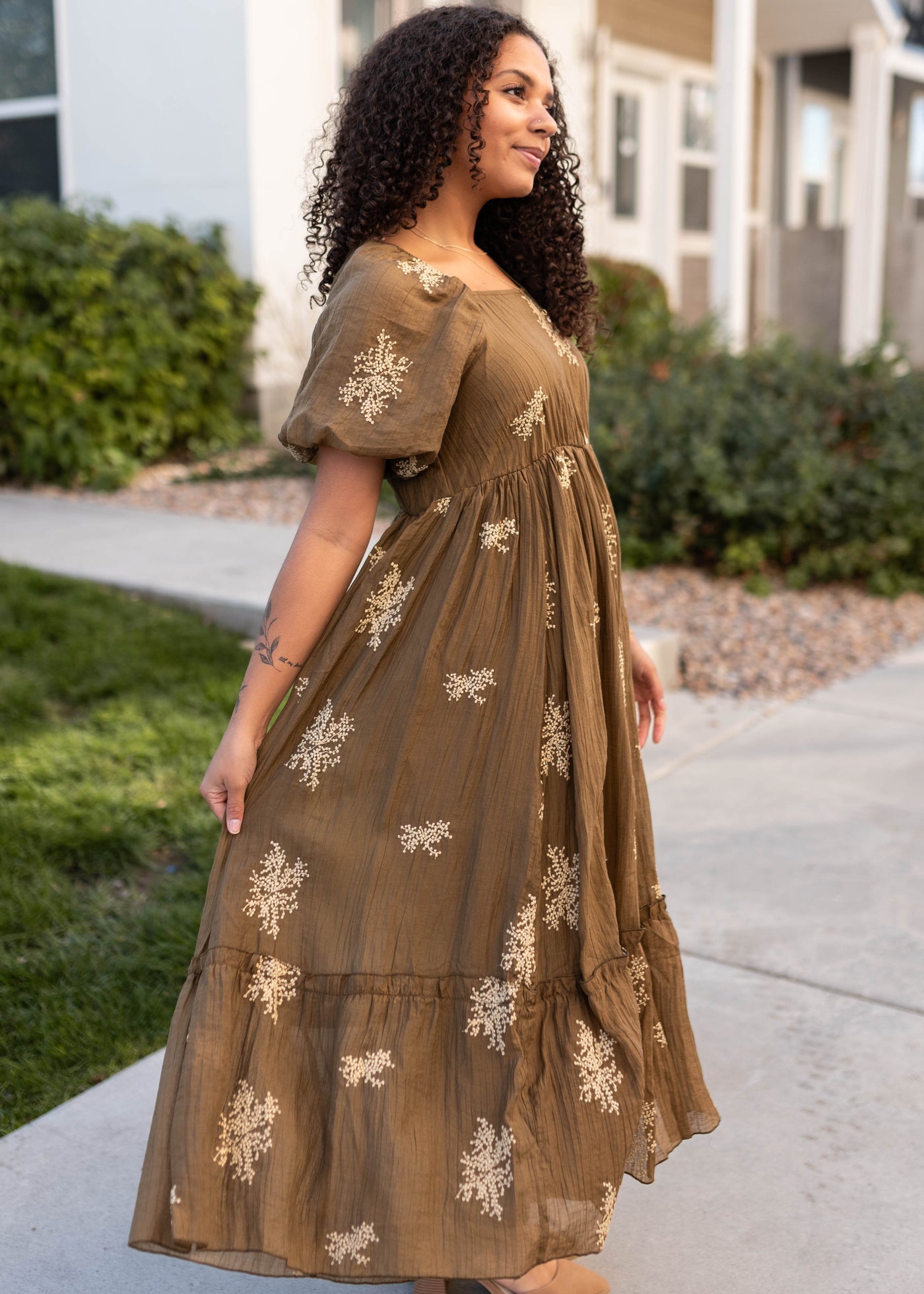 Side view of the khaki embroidered dress with ivory flowers