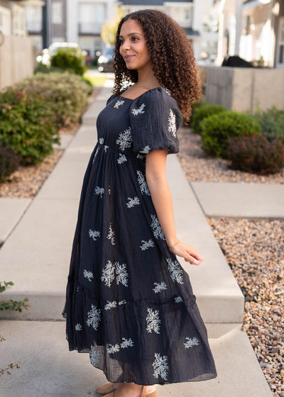 Side view of the navy embroidered dress