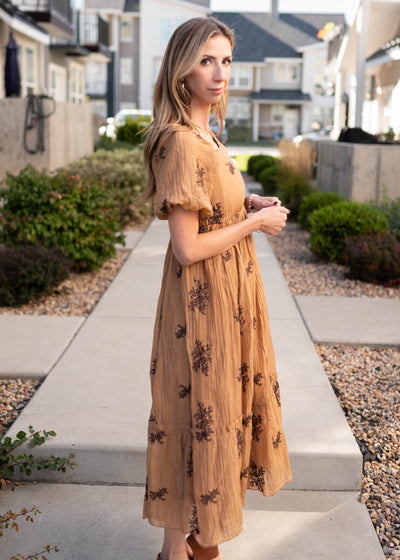 Side view of the short sleeve tan embroidered dress