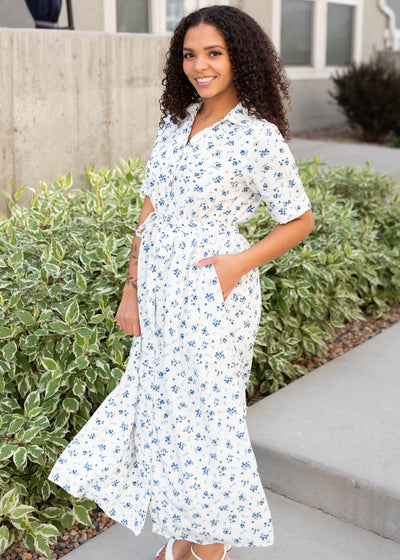 Side view of the white floral button down dress with pockets