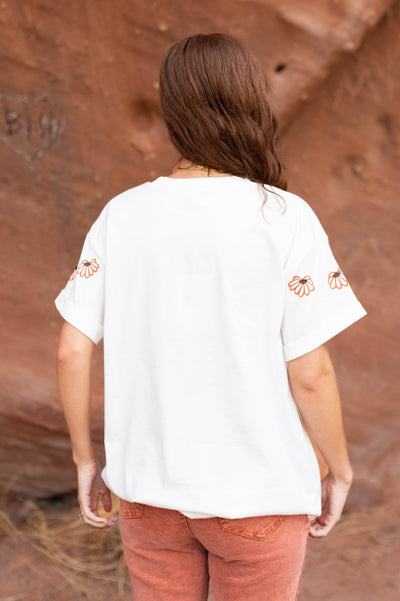 Back view of a ivory floral top