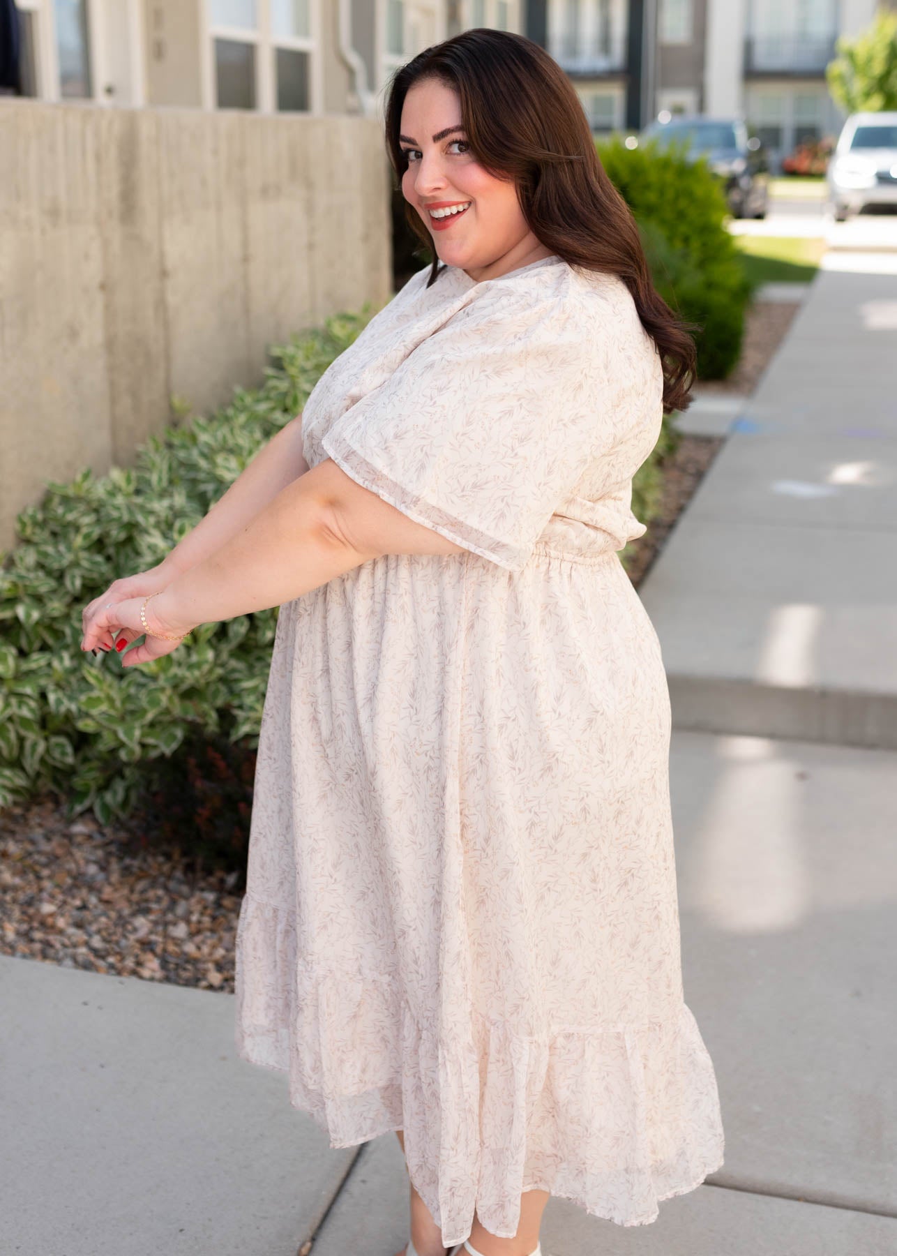 Side view of the plus size beige floral dress