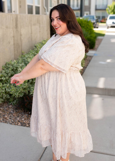 Side view of the plus size beige floral dress