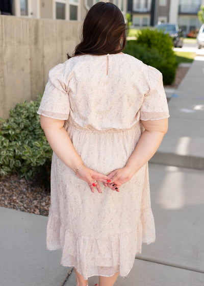 Back view of the beige floral dress in plus size