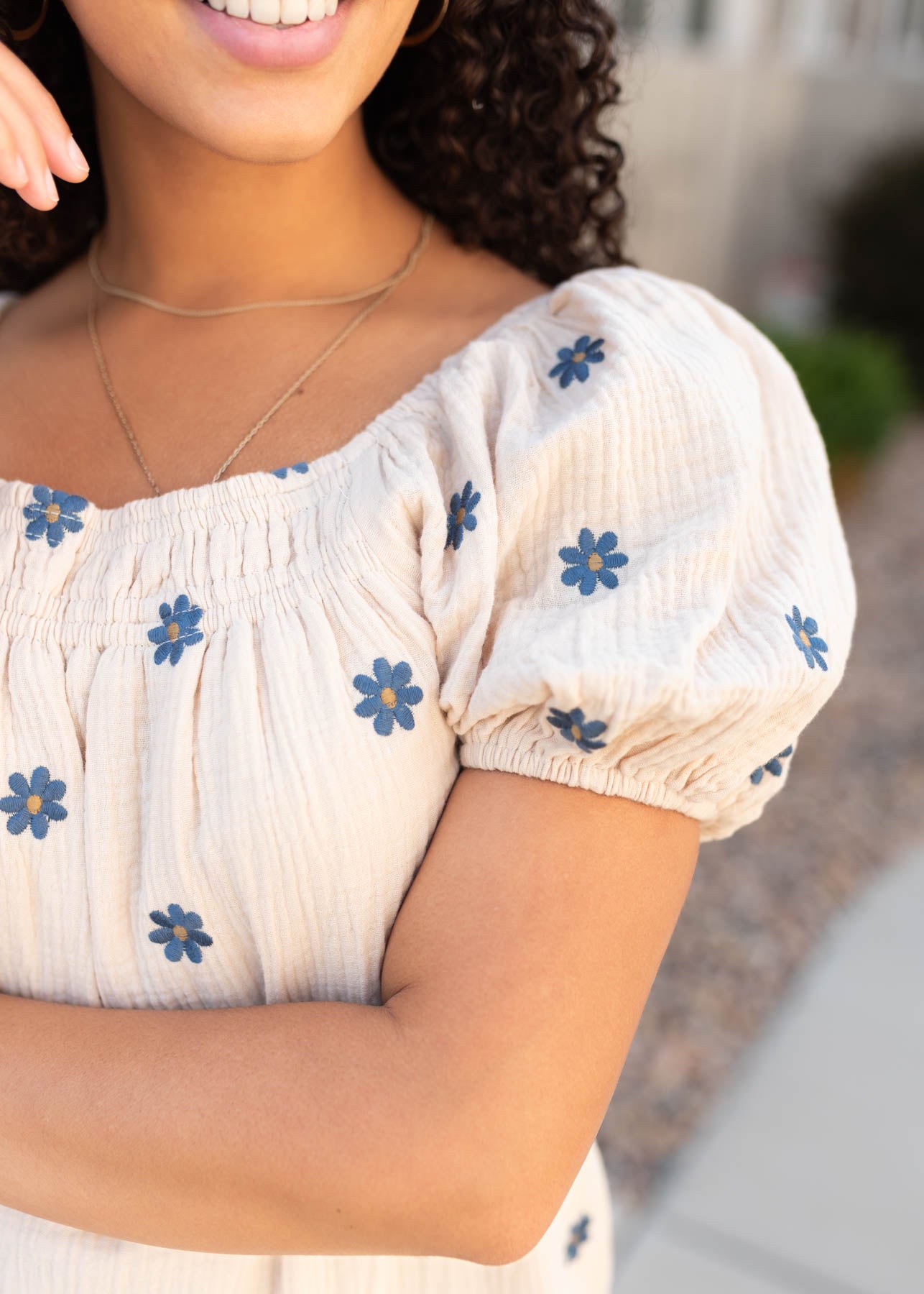 Close up of the sleeve and fabric on the natural embroidered dress