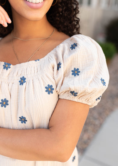 Close up of the sleeve and fabric on the natural embroidered dress
