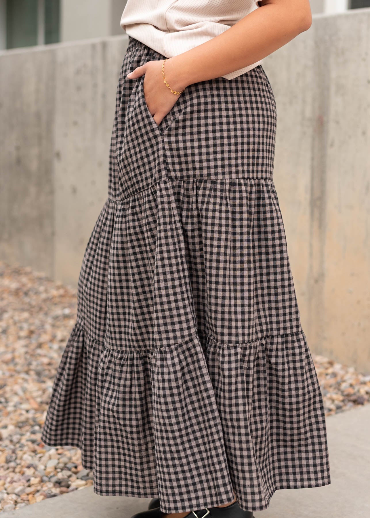 Side view of the black gingham skirt with pockets