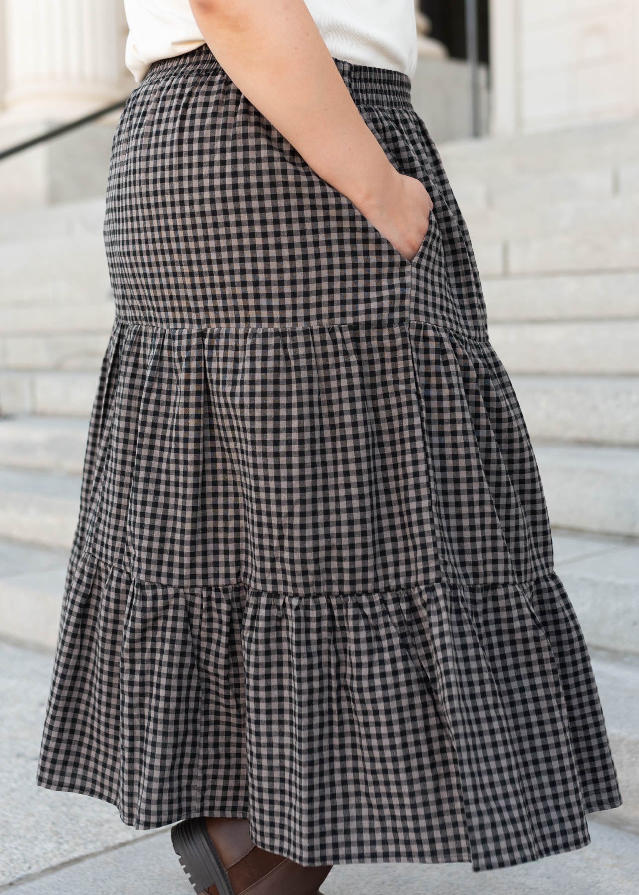 Side view of the plus size black gingham skirt with pockets