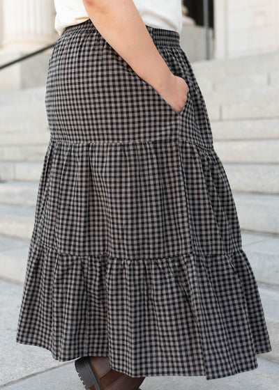 Side view of the plus size black gingham skirt with pockets