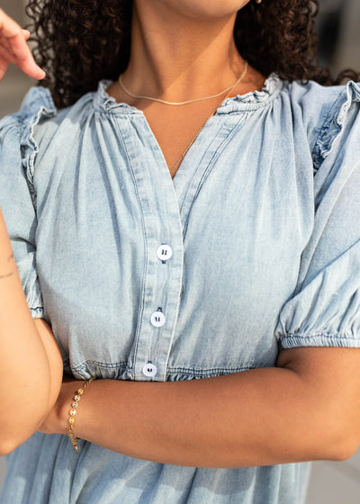 Close up of the bodice and ruffles on the chambray button down dress