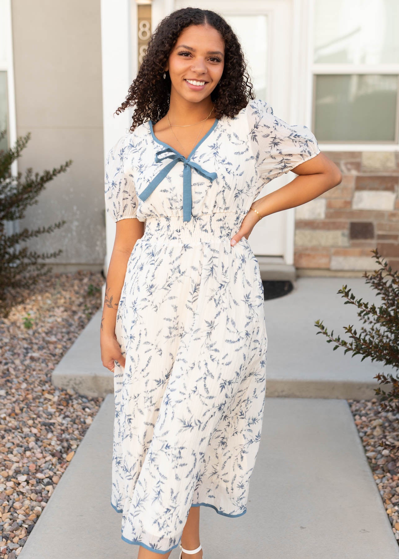 Cream floral dress with blue trim at Lena Layne
