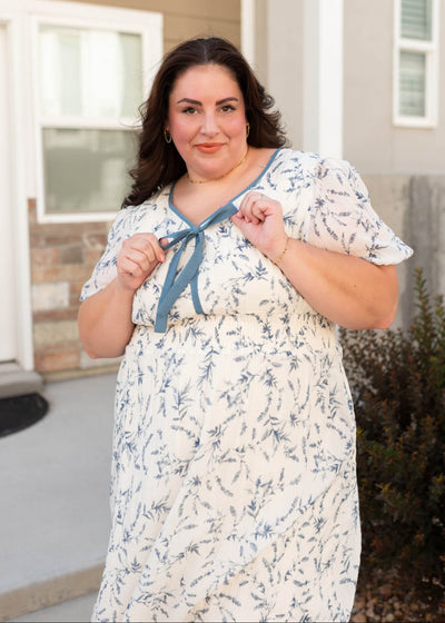 Modest cream floral dress with short sleeves and a bow in plus size