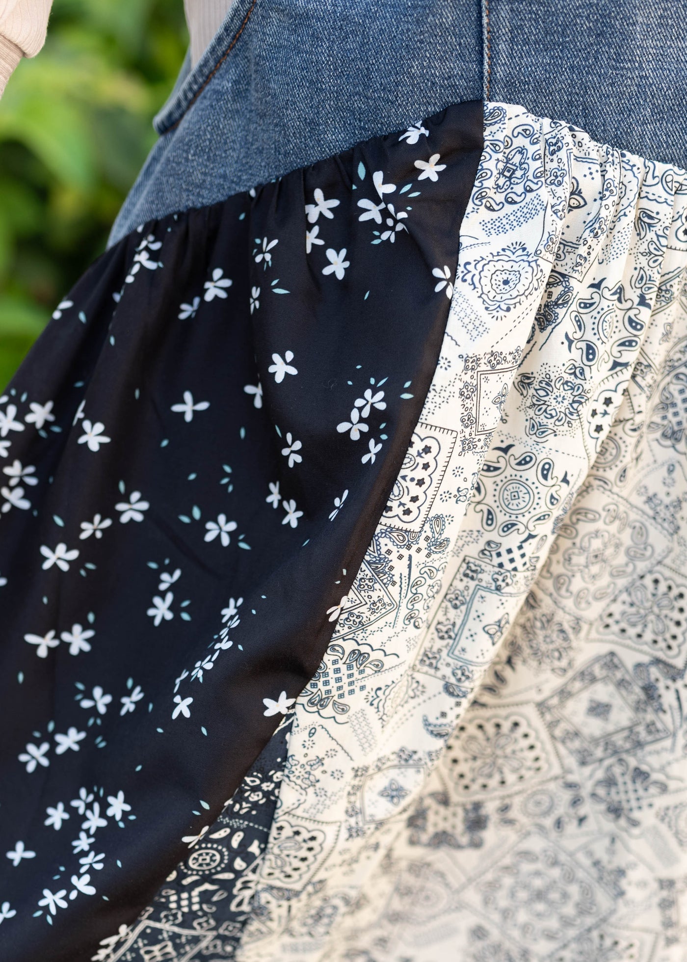Close up of the fabric on the skirt of the denim patchwork overall dress