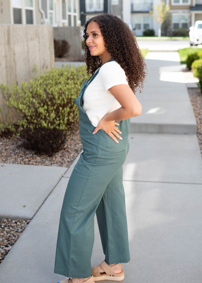 Side view of the dark jade knit strap overall