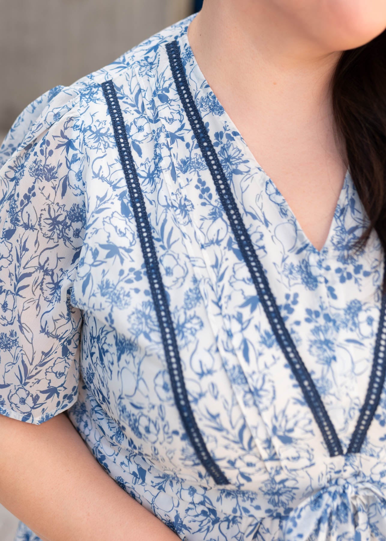 Close up of the blue trim on the blue floral dress in plus size