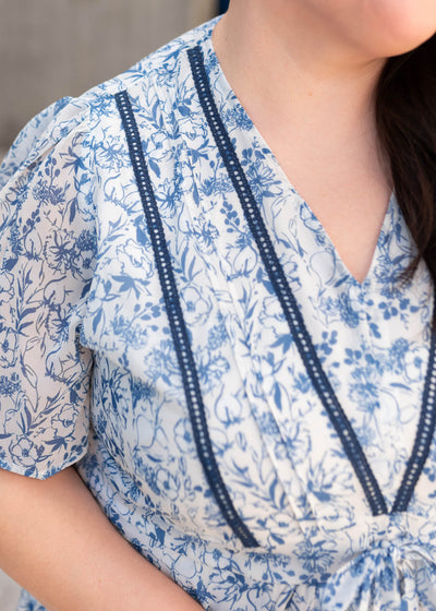 Close up of the blue trim on the blue floral dress in plus size