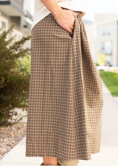 Side view of the olive plaid skirt with pockets